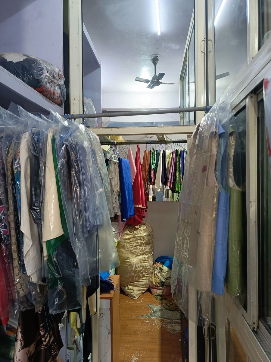 Dry cleaned garments in protective covers at Balaji Dry Cleaners, Janakpuri